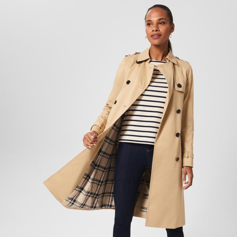 Woman in trench coat and striped tee