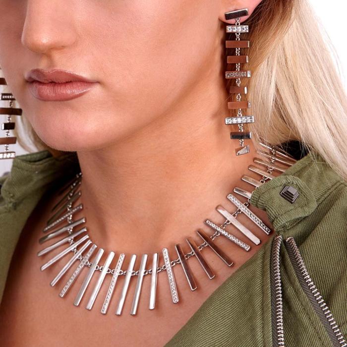 Blonde model wears modern silver and diamond necklace and earrings